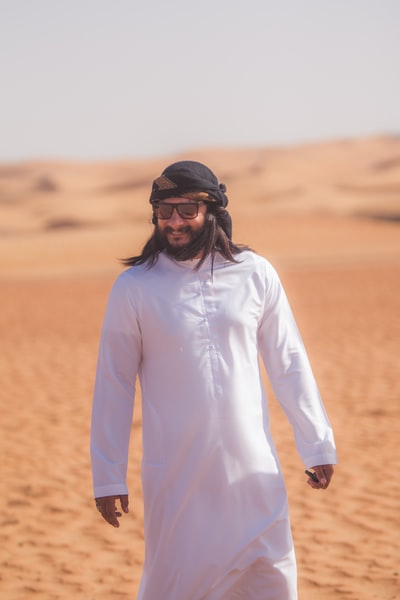 The man in white long sleeve shirt, wearing a black sunglasses
